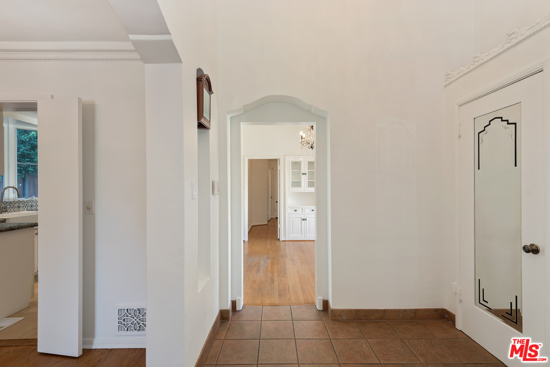 357 South La Peer Drive Beverly Hills, CA 90211 - Photo 3 of 31 a view of a hallway with wooden floor and closet