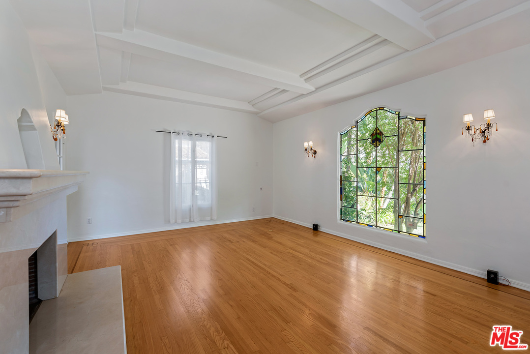 357 South La Peer Drive Beverly Hills, CA 90211 - Photo 5 of 31 a view of an empty room with a window and wooden floor