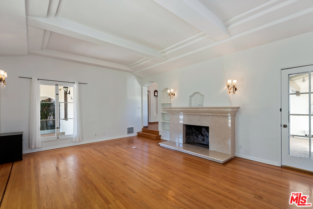 357 South La Peer Drive Beverly Hills, CA 90211 - Photo 7 of 31 wooden floor fireplace and windows in an empty room