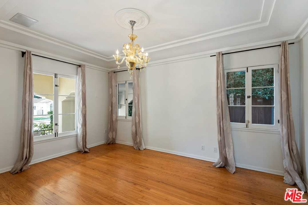 357 South La Peer Drive Beverly Hills, CA 90211 - Photo 8 of 31 wooden floor in an empty room with a window
