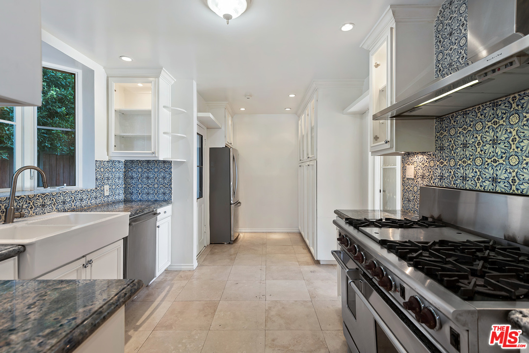 357 South La Peer Drive Beverly Hills, CA 90211 - Photo 10 of 31 a kitchen with stainless steel appliances granite countertop a stove a sink and a refrigerator
