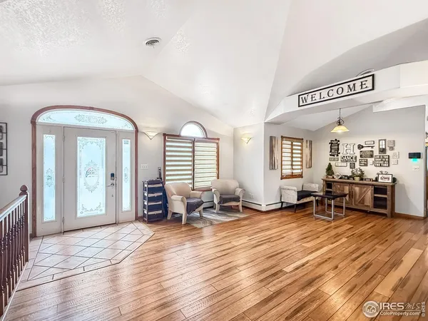 a living room with furniture window and wooden floor