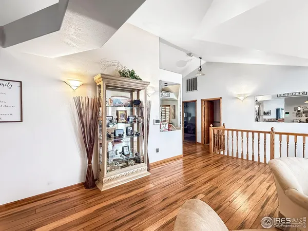 a view of a livingroom with a dinning area hardwood floor and staircase