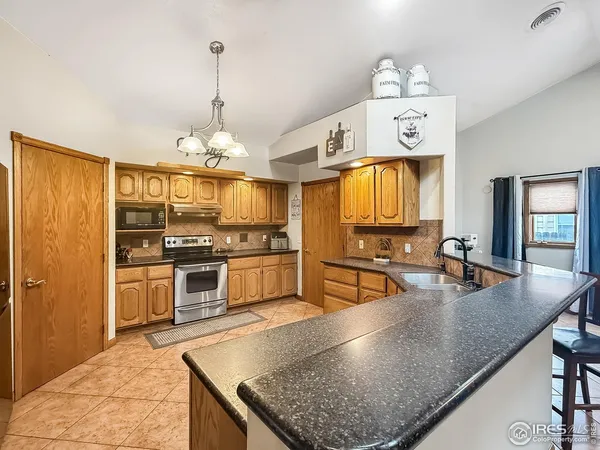 a kitchen with stainless steel appliances granite countertop a stove and a sink