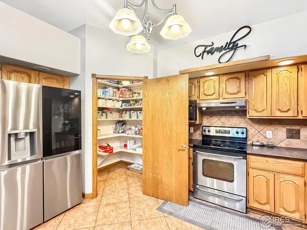 a kitchen with stainless steel appliances granite countertop a stove a washer and dryer