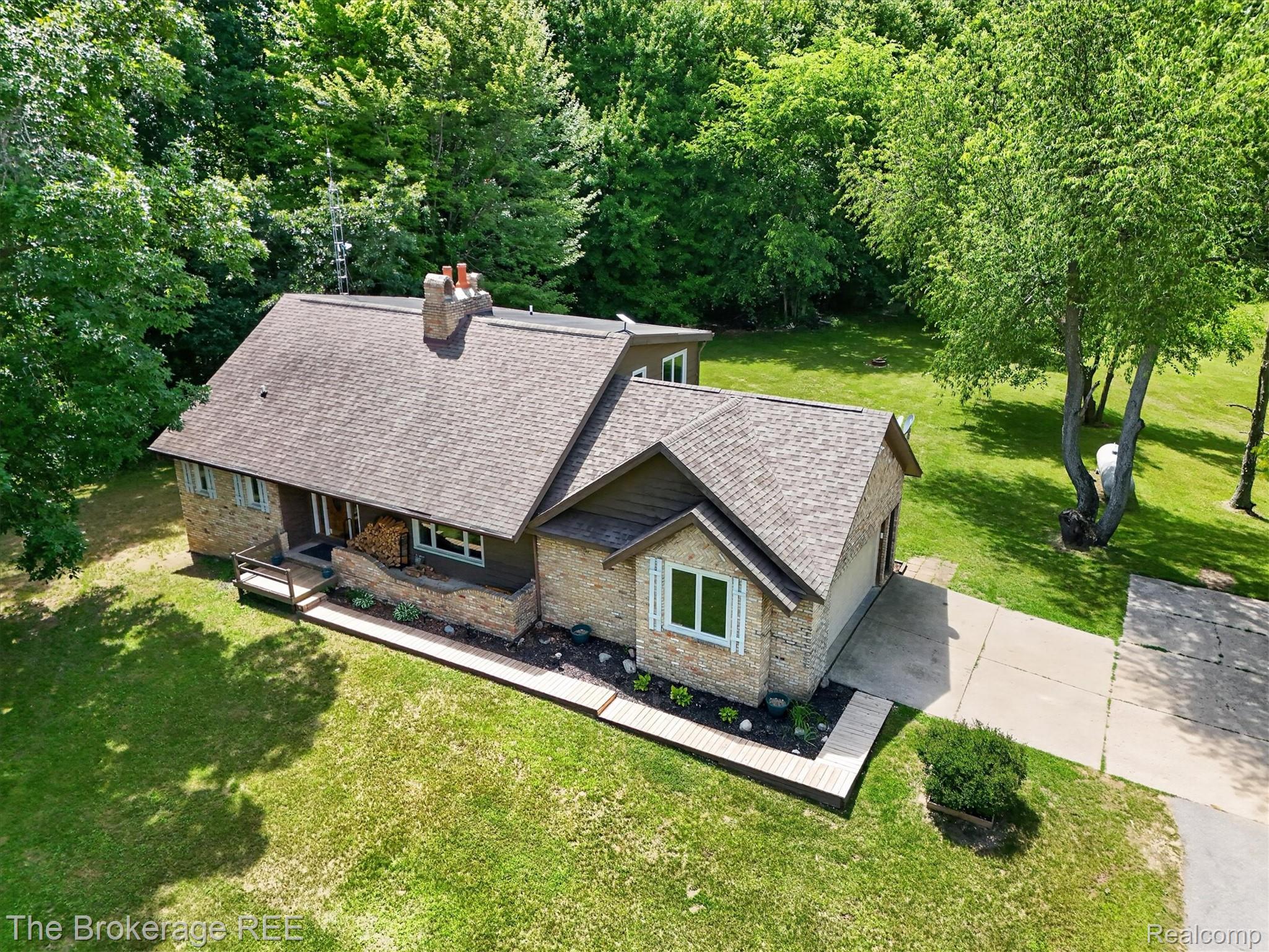 13269 North Genesee Road Clio, MI 48420 - Photo 53 of 67 Multi-level residential structure featuring a shingle roof and brick facade