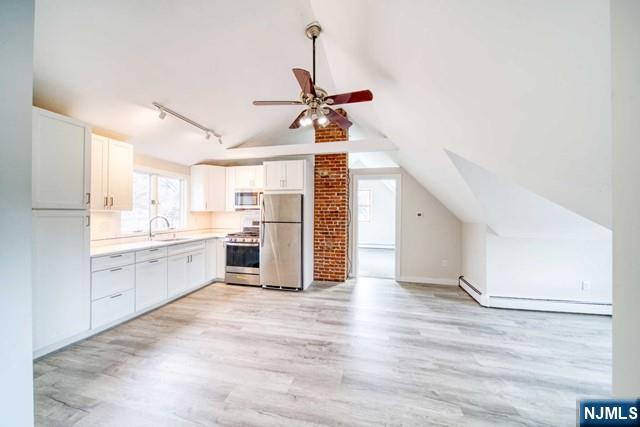 334 South Broad Street, Unit B Ridgewood, NJ 07450 - Photo 2 of 9 a view of a kitchen with wooden floor and a window