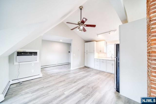 334 South Broad Street, Unit B Ridgewood, NJ 07450 - Photo 4 of 9 a view of a kitchen with wooden cabinet and a refrigerator