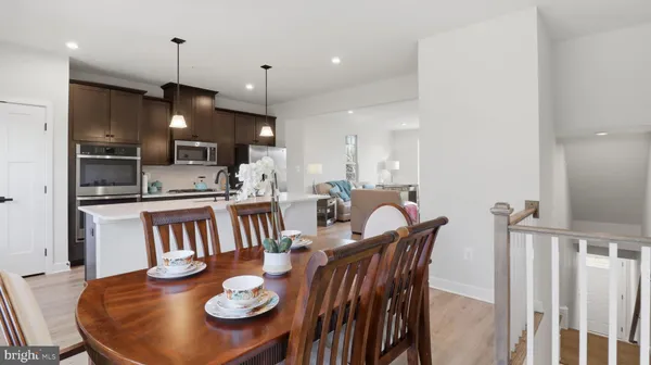 a large kitchen with a table and chairs