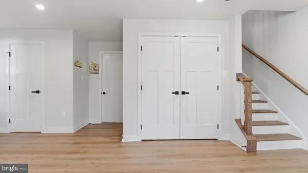 a view of room with wooden floor and entryway