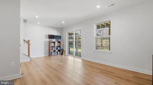 a big room with wooden floor and windows