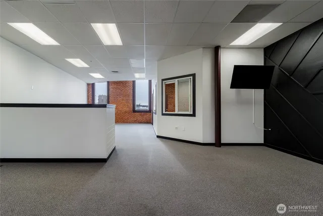 a view of a kitchen with furniture and a refrigerator