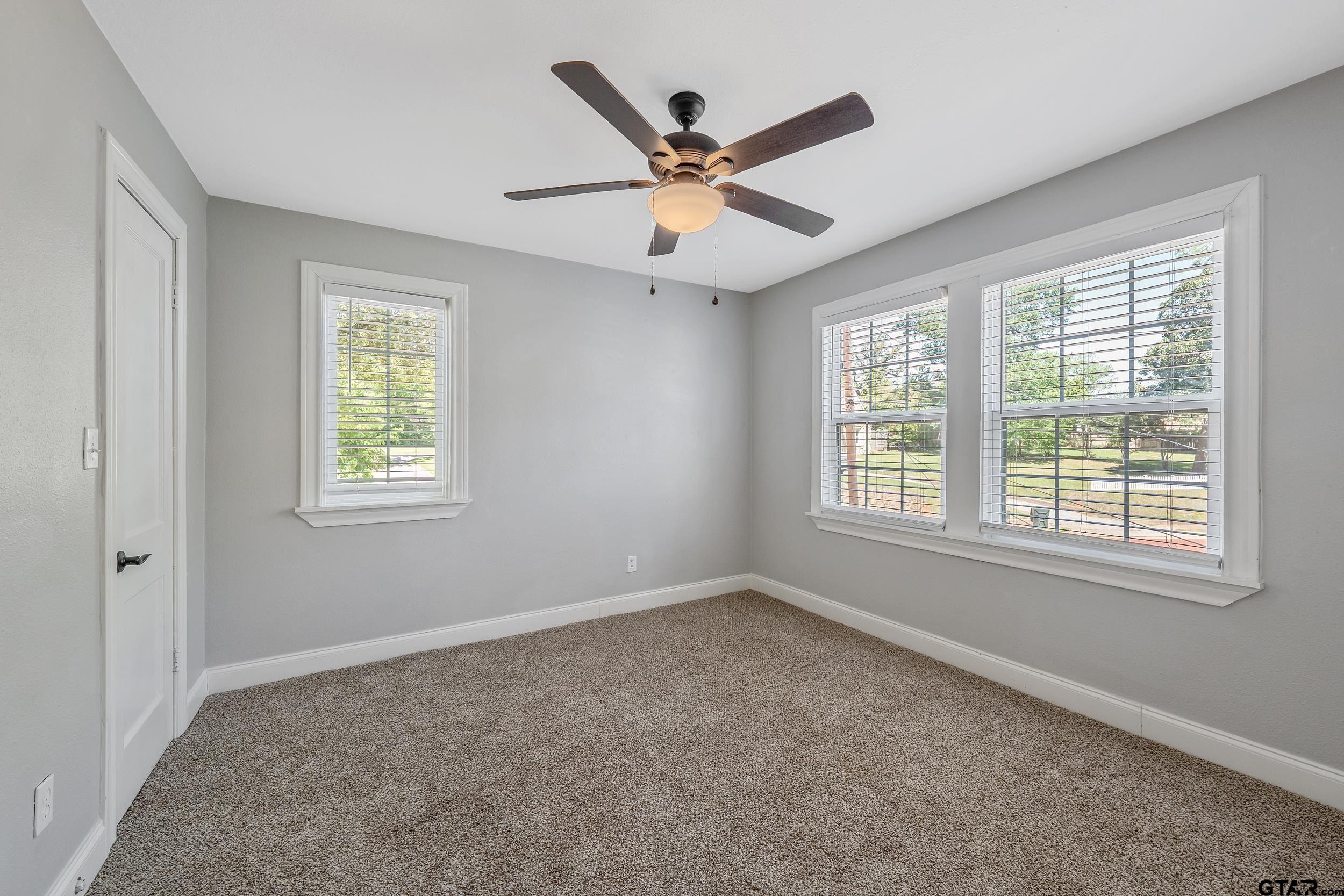 434 South Vine Avenue Tyler, TX 75702 - Photo 21 of 29 a view of a livingroom with a ceiling fan & windows