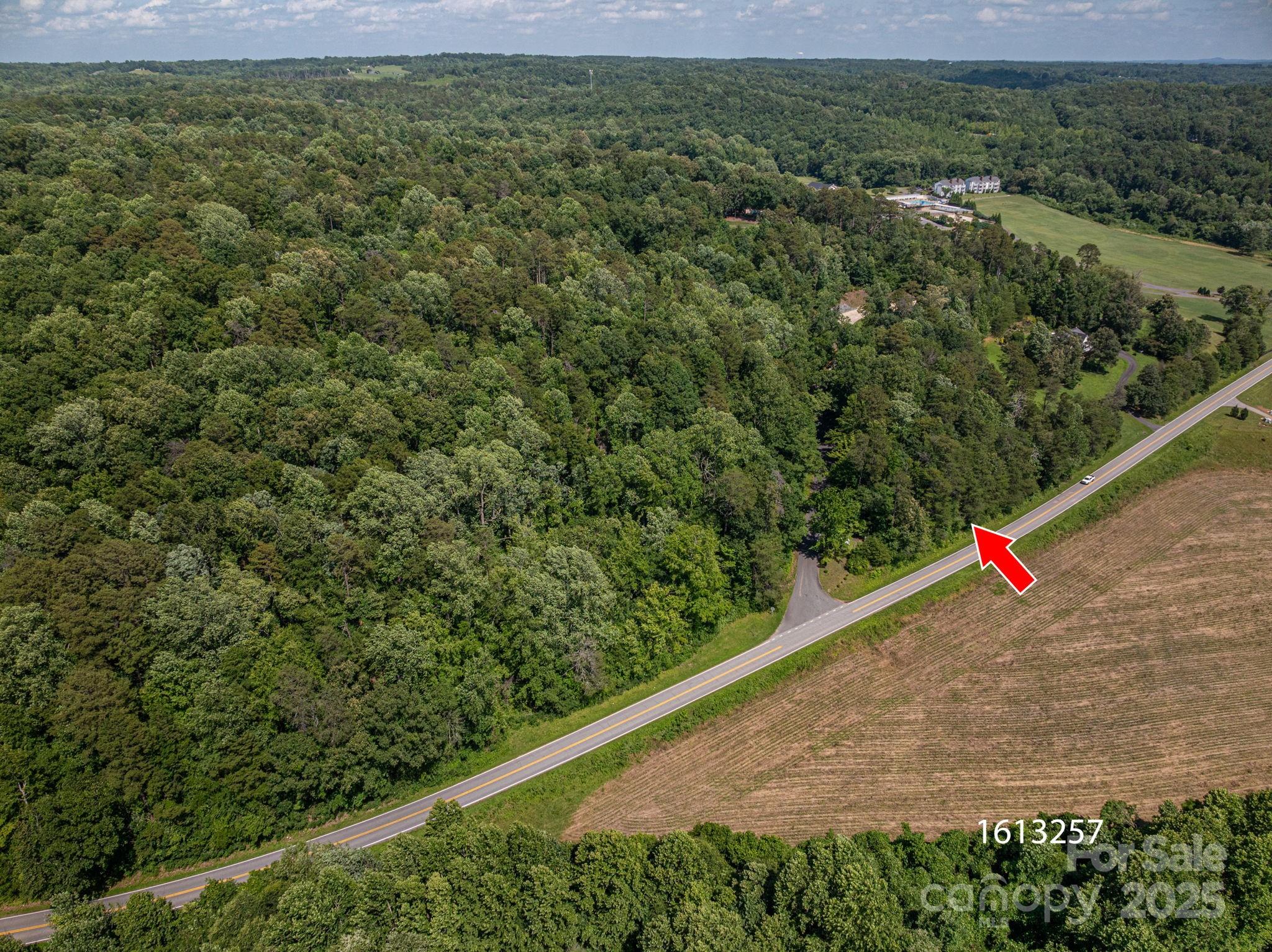 Lot 148 Plantation Drive Rutherfordton, NC 28139 - Photo 3 of 19 a view of a field with plants and wooden fence