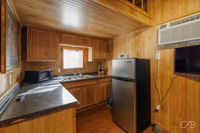 a kitchen with a refrigerator sink and stove