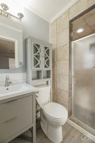a bathroom with a sink toilet and shower