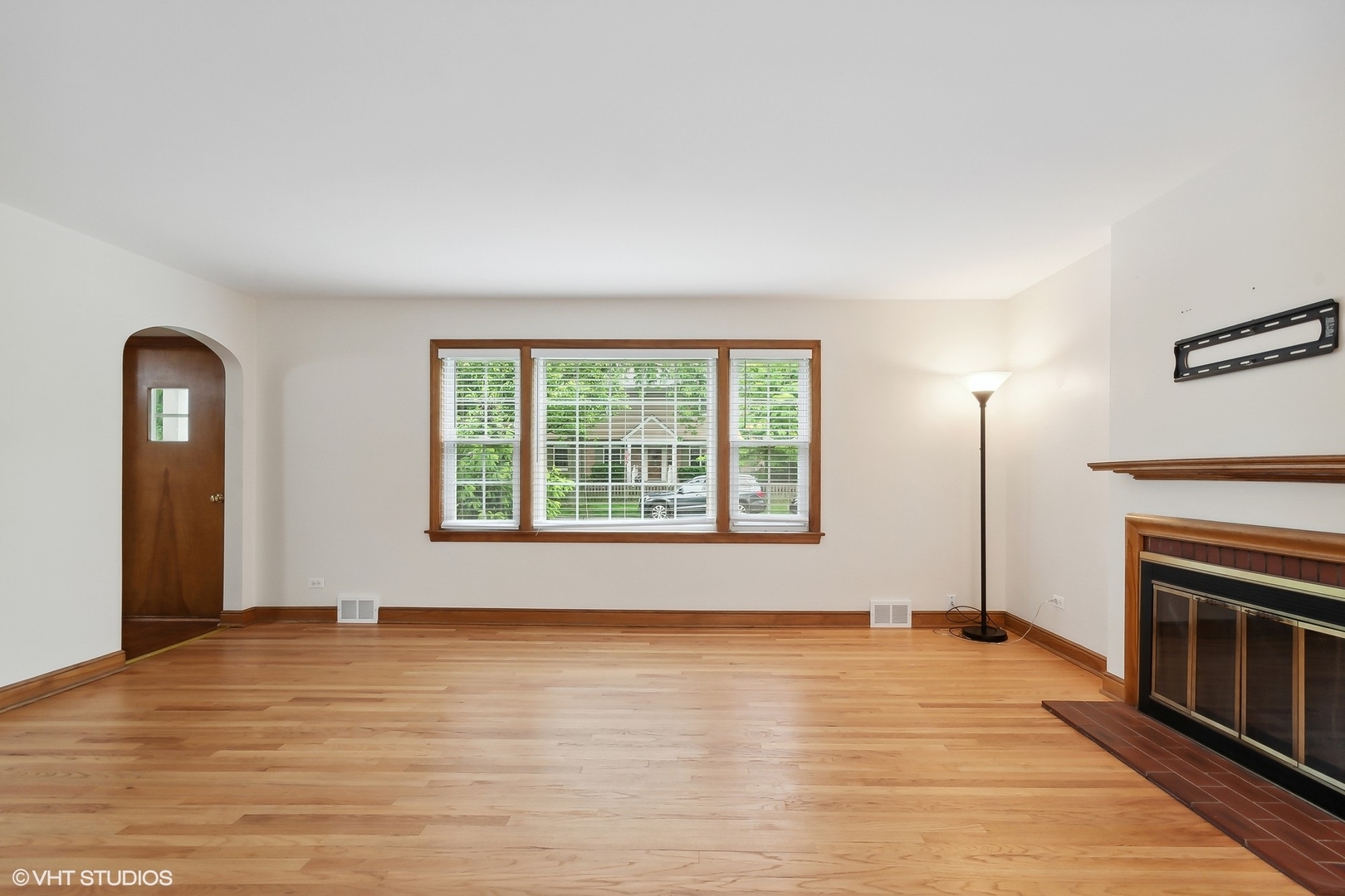 402 Berry Road Barrington, IL 60010 - Photo 2 of 22 a view of an empty room with wooden floor fireplace and a window