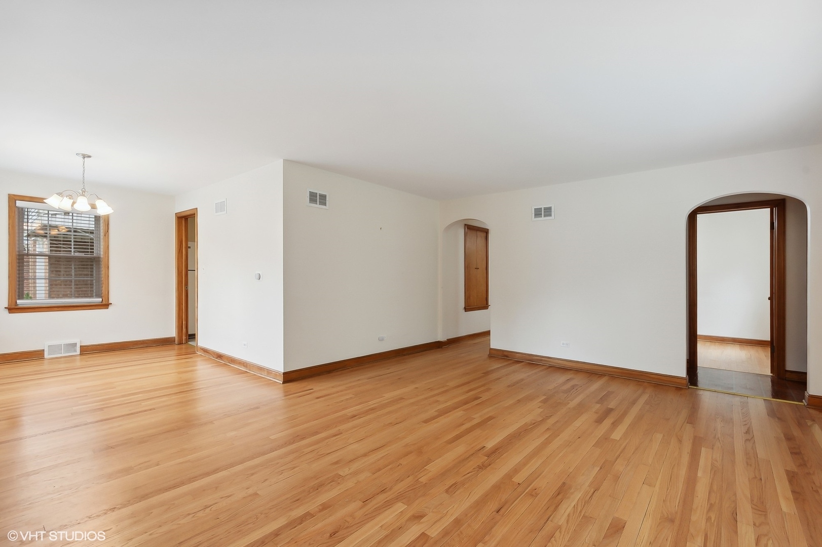 402 Berry Road Barrington, IL 60010 - Photo 4 of 22 a view of an empty room with window and wooden floor