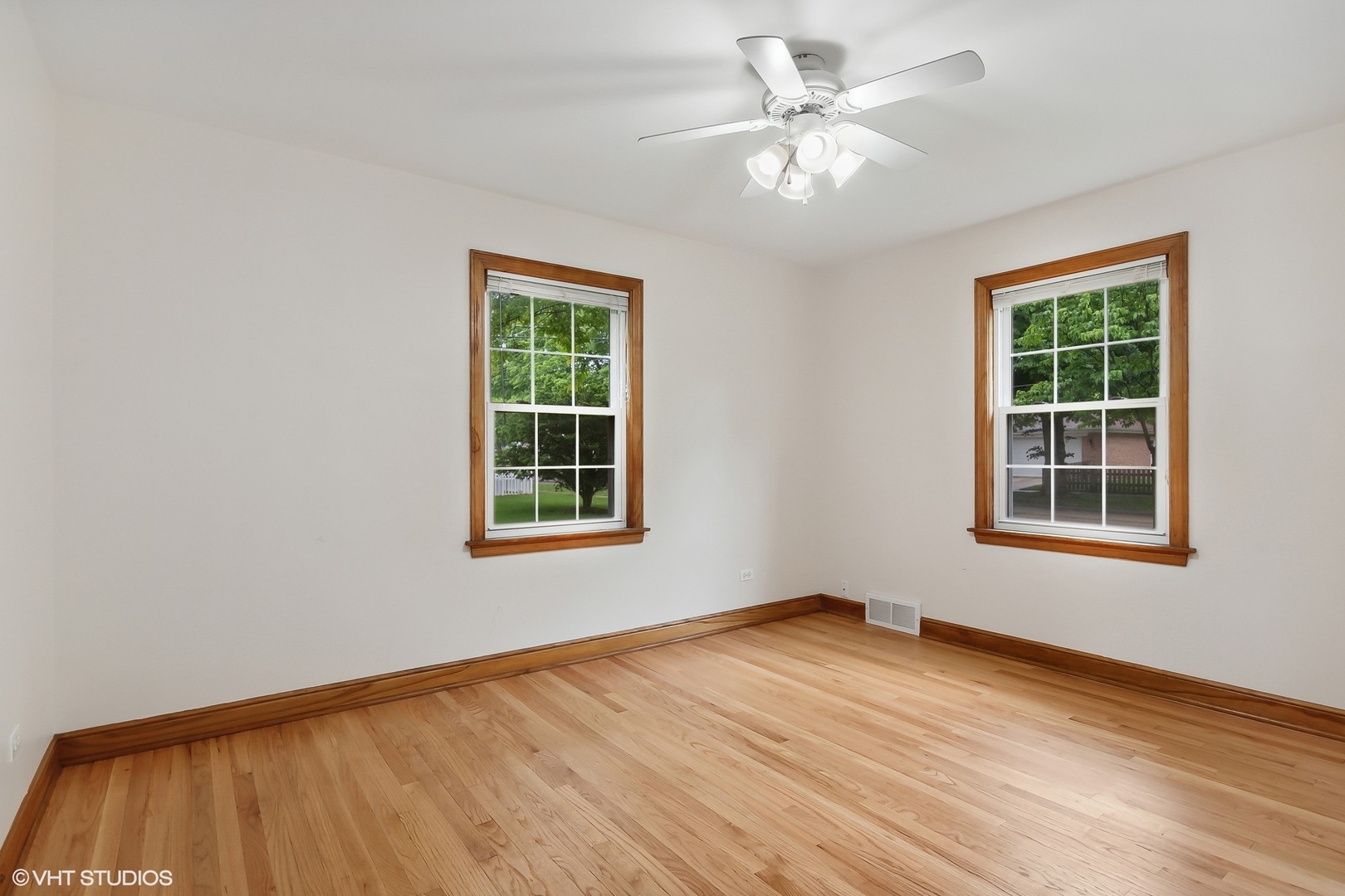 402 Berry Road Barrington, IL 60010 - Photo 8 of 22 an empty room with wooden floor and windows