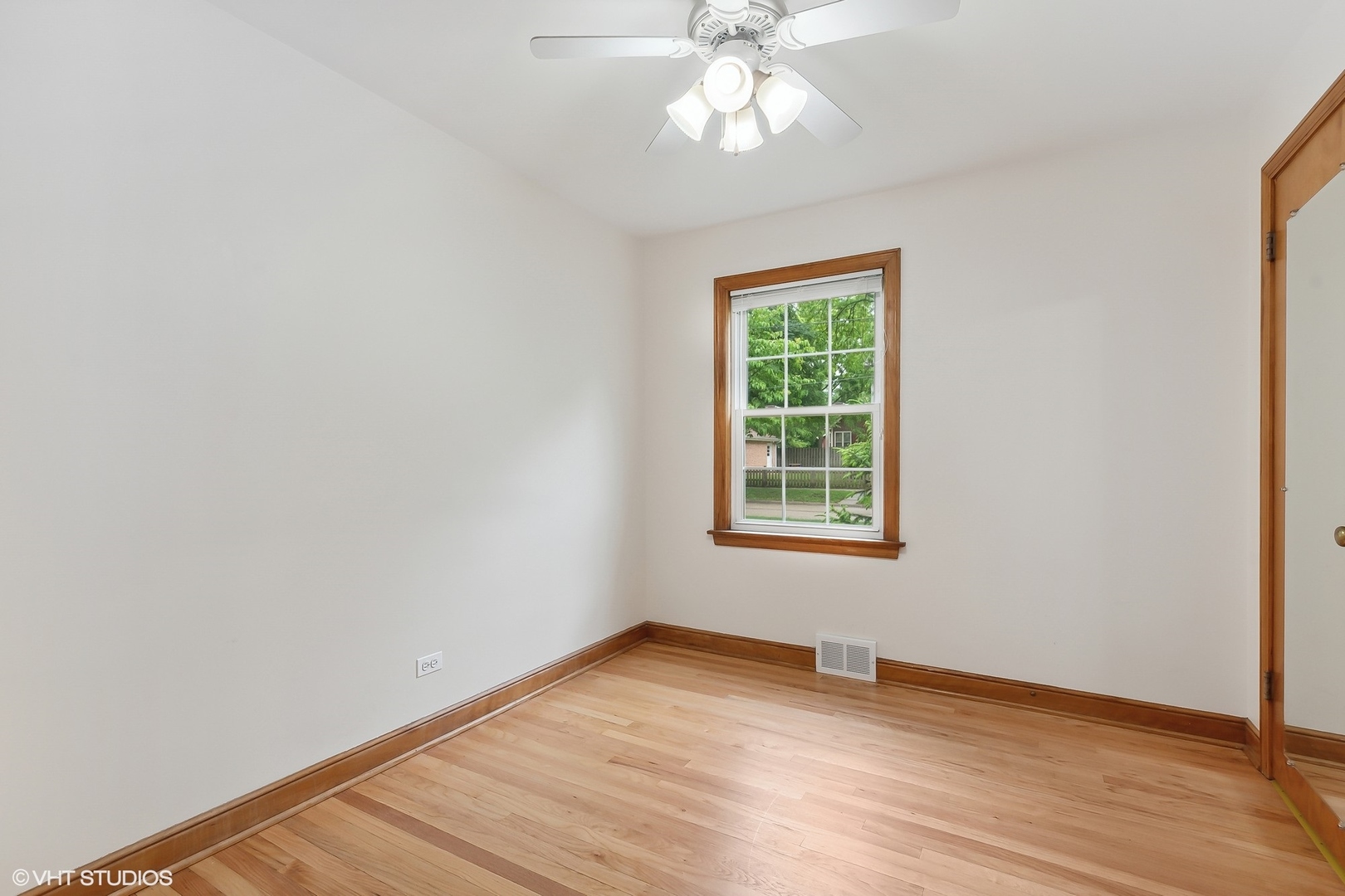 402 Berry Road Barrington, IL 60010 - Photo 9 of 22 an empty room with wooden floor chandelier fan and windows
