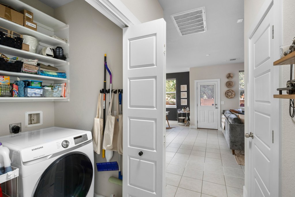 610 Bernstein Street, Unit 14 Austin, TX 78745 - Photo 15 of 39 a view of washer and dryer with kitchen in the background
