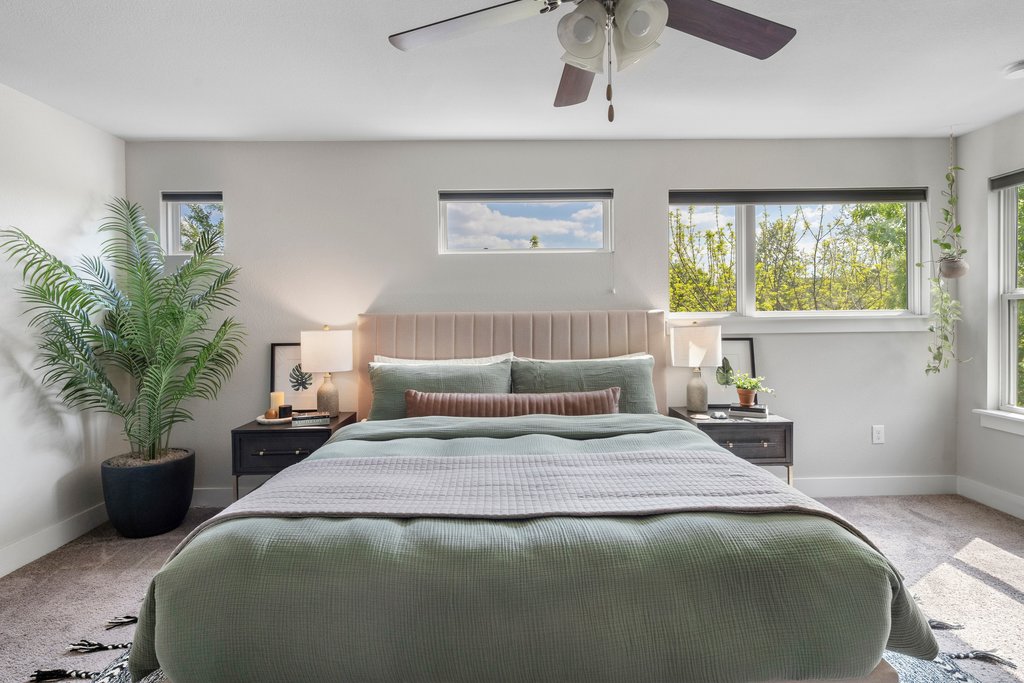 610 Bernstein Street, Unit 14 Austin, TX 78745 - Photo 20 of 39 a bedroom with a bed a chandelier and a large window