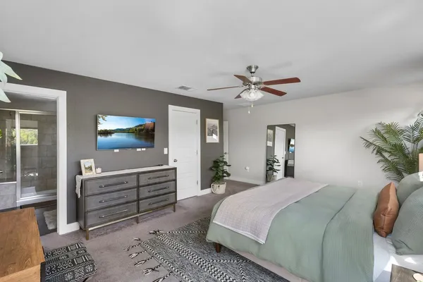 a bedroom with a bed and a chandelier