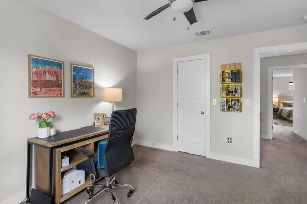 a view of a workspace with furniture and a couch