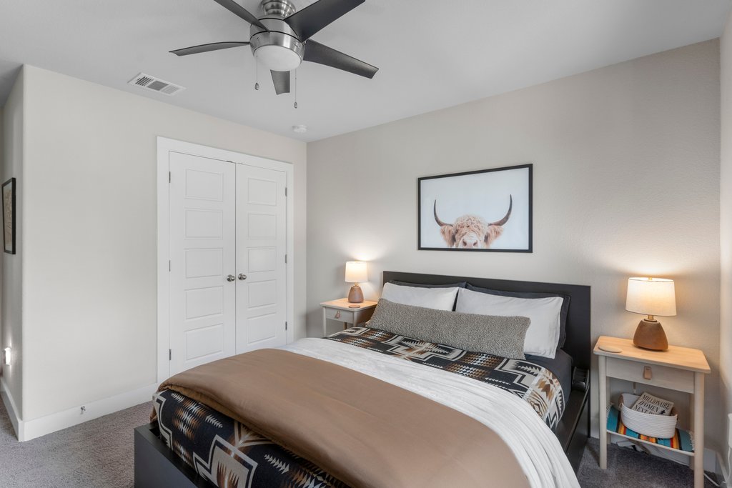 610 Bernstein Street, Unit 14 Austin, TX 78745 - Photo 30 of 39 a bedroom with a bed and a chandelier