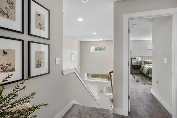 a hall way with furniture and a gate