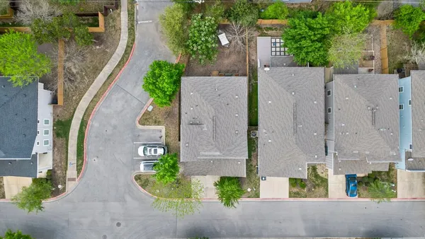 an aerial view of a house with outdoor space and street view