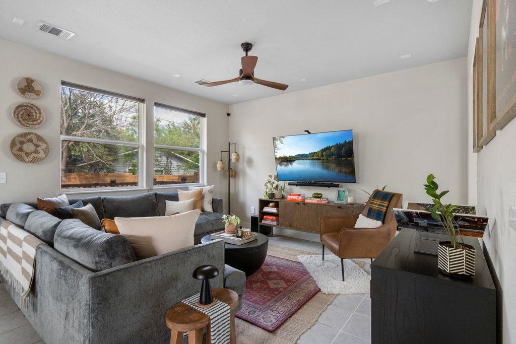 610 Bernstein Street, Unit 14 Austin, TX 78745 - Photo 7 of 39 a living room with furniture a flat screen tv and a large window