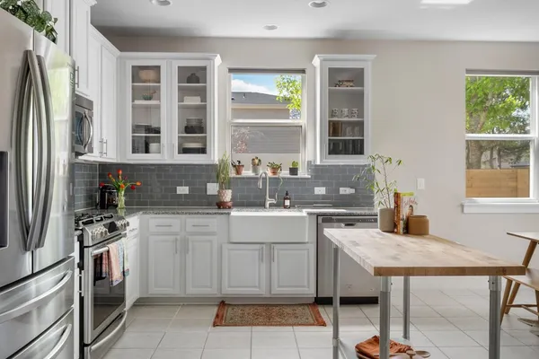 a kitchen with a stove a sink and a refrigerator