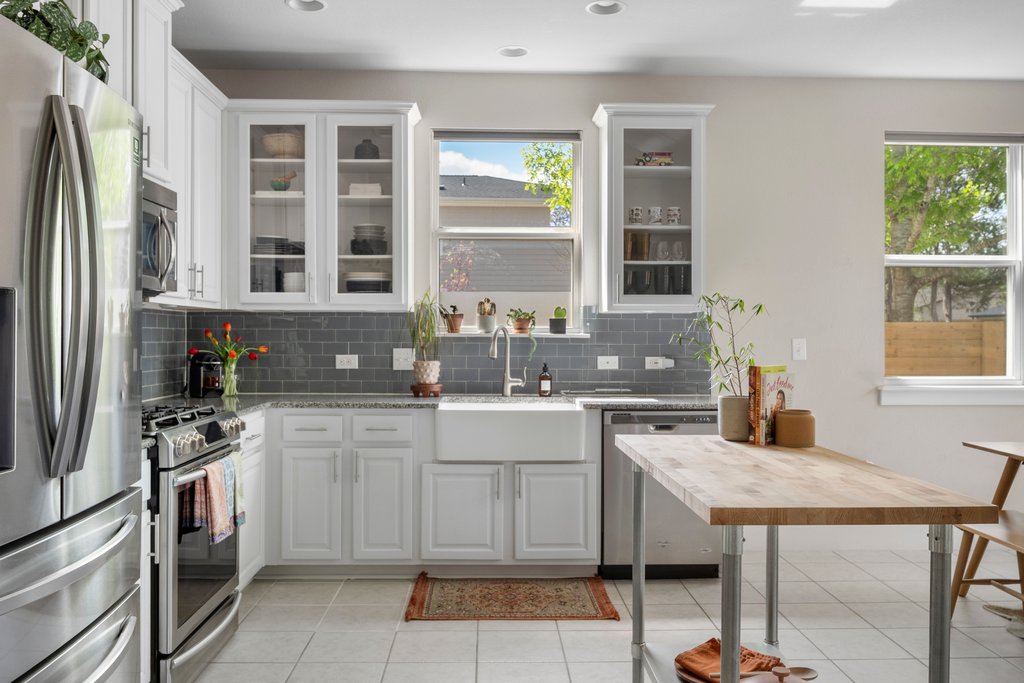 610 Bernstein Street, Unit 14 Austin, TX 78745 - Photo 10 of 39 a kitchen with a stove a sink and a refrigerator