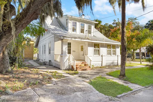 a front view of a house with a yard table and chairs