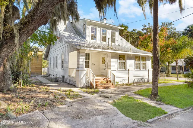 a front view of a house with a yard table and chairs