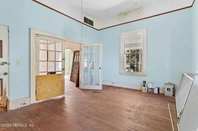 an empty room with windows and closet