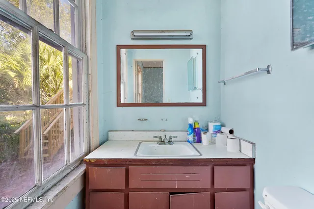 a bathroom with a sink vanity and a mirror