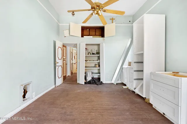 a view of an empty room and entryway with wooden floor
