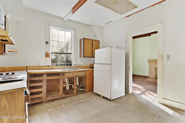 a utility room with cabinets washer and dryer