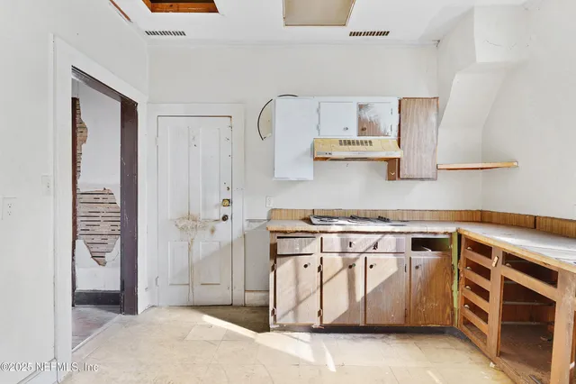 a kitchen with stainless steel appliances granite countertop a stove and a refrigerator