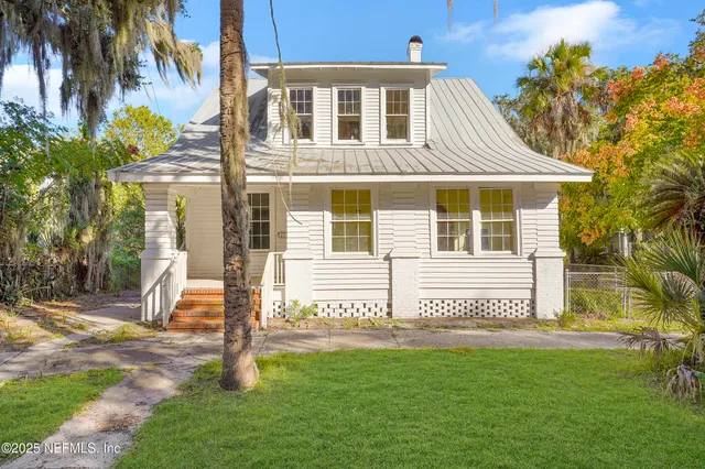 a front view of a house with a garden