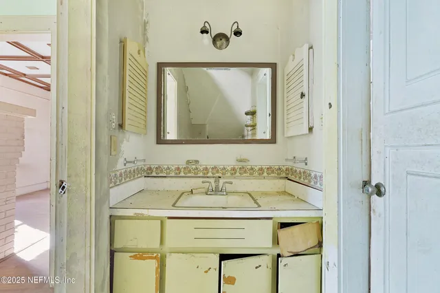 a bathroom with a sink and a mirror