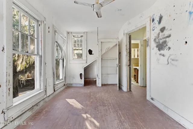 a view of a big room with windows and entryway