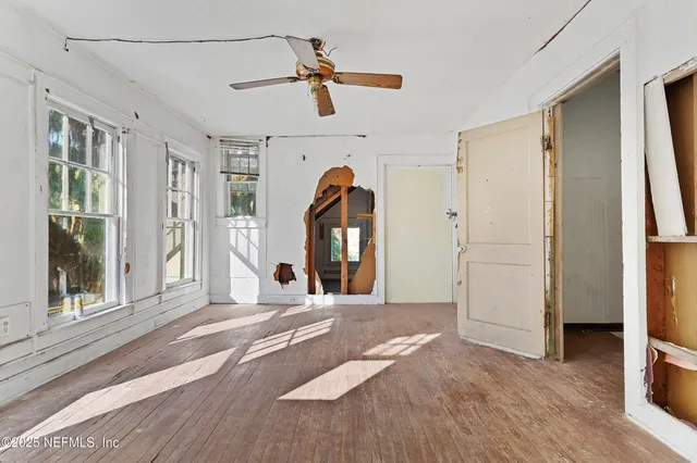 a view of a livingroom with a furniture hardwood floor and a ceiling fan