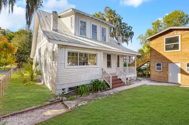 a front view of a house with a garden and patio