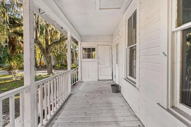 a view of a porch with wooden floor and stairs