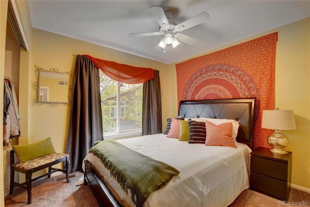 a bedroom with a large bed and a window