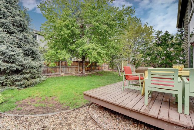a view of a table and chairs in the garden