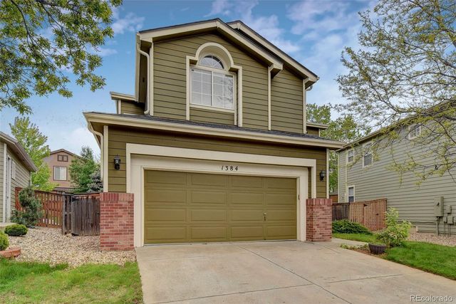 a front view of a house with garage